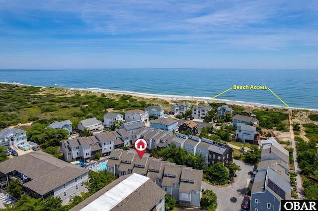 bird's eye view with a residential view, a water view, and a beach view