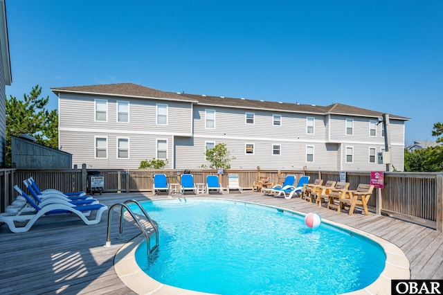 view of pool featuring a fenced in pool and a wooden deck