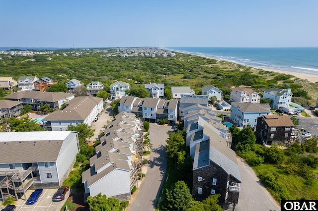 aerial view with a beach view, a water view, and a residential view