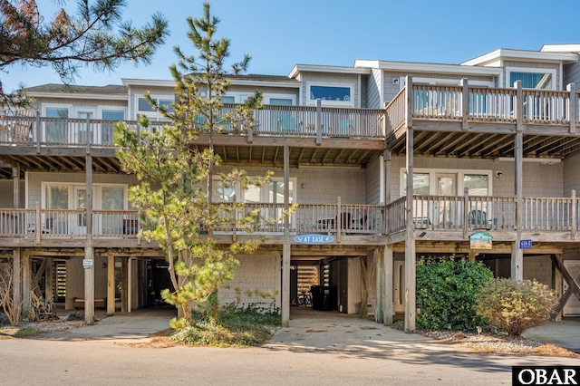 view of property featuring a carport and driveway