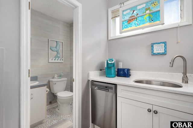 bathroom featuring toilet, tile patterned flooring, a textured ceiling, and vanity