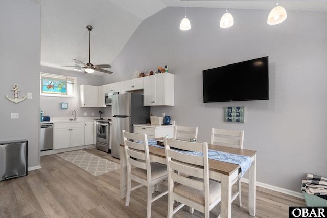 kitchen featuring appliances with stainless steel finishes, white cabinets, and light countertops