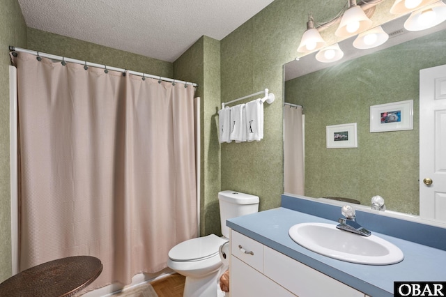 full bath with a textured ceiling, toilet, and vanity