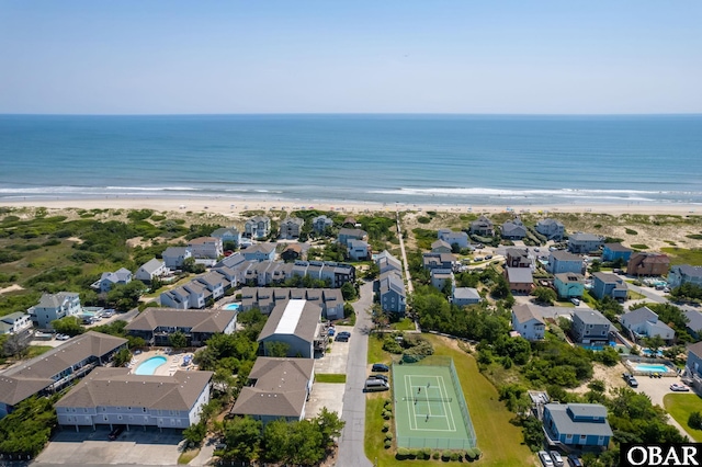 birds eye view of property featuring a beach view, a water view, and a residential view