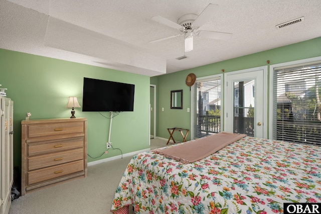 bedroom featuring a textured ceiling, access to outside, and visible vents