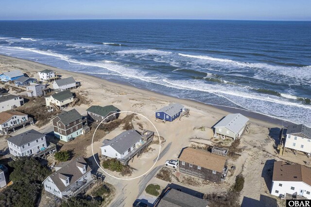 aerial view with a residential view, a water view, and a beach view