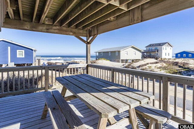 wooden terrace featuring a water view