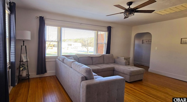 1034 N NC Highway 37, Gates, NC 27937 - living room featuring arched walkways, wood finished floors, a ceiling fan, and baseboards