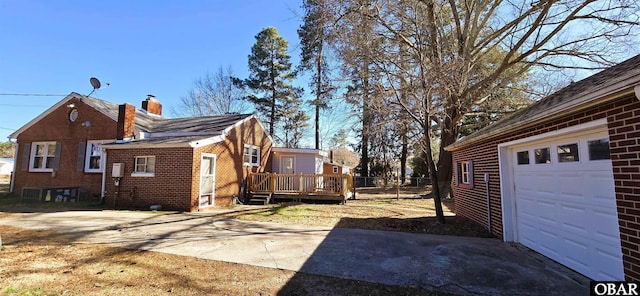 1034 N NC Highway 37, Gates, NC 27937 - view of property exterior with a chimney, driveway, a deck, a garage, and brick siding