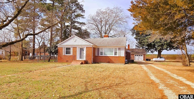 bungalow featuring driveway, brick siding, a chimney, crawl space, and a front yard