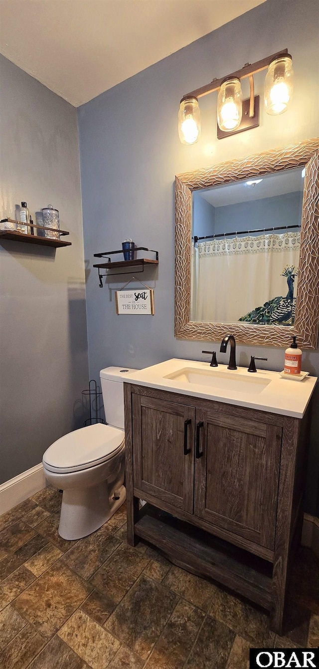 1034 N NC Highway 37, Gates, NC 27937 - full bathroom with toilet, stone tile floors, vanity, and baseboards