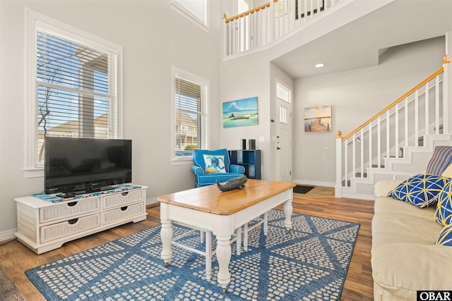 715 Ridge Point Dr Lot 20, Corolla, NC 27927 - living room featuring stairs, wood finished floors, and a towering ceiling
