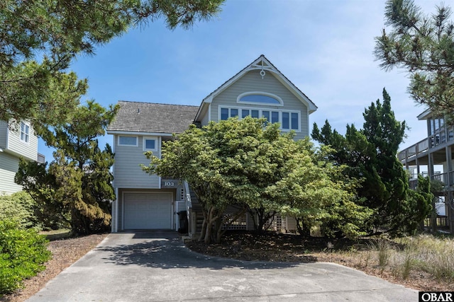 view of front facade featuring an attached garage and aphalt driveway