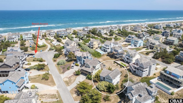 bird's eye view with a residential view, a beach view, and a water view