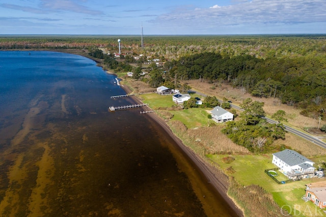 drone / aerial view with a forest view and a water view