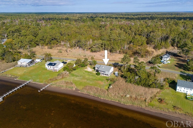 birds eye view of property featuring a view of trees