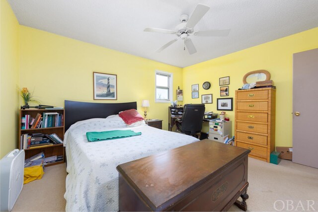 bedroom featuring a ceiling fan and light colored carpet