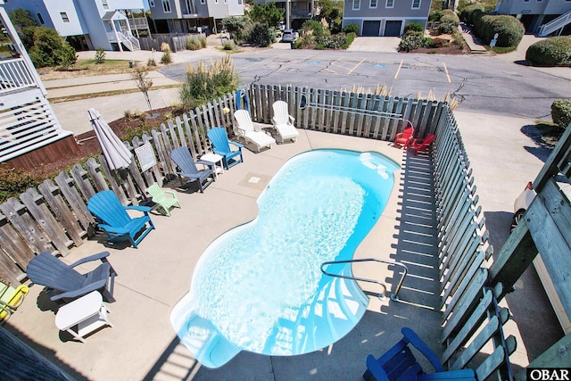 pool featuring a patio area and fence