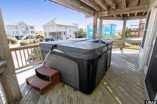 wooden terrace with a hot tub and a residential view