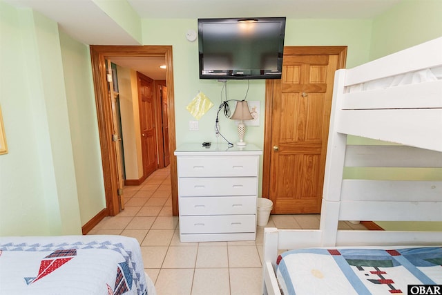 bedroom featuring light tile patterned flooring and baseboards