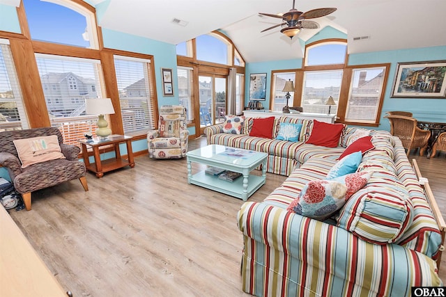 living area with light wood-style flooring, visible vents, and a wealth of natural light