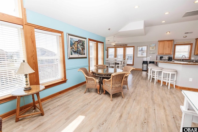 dining space featuring light wood-style floors, lofted ceiling, visible vents, and recessed lighting