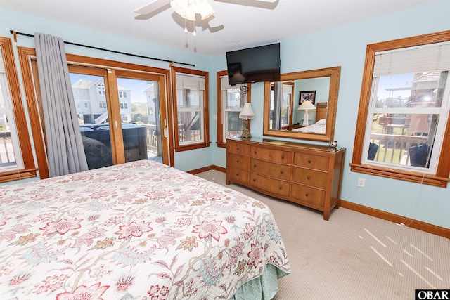 bedroom with baseboards, multiple windows, and access to exterior