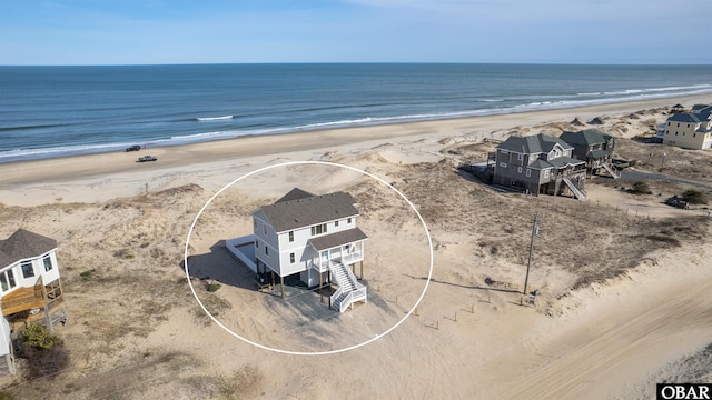 bird's eye view with a view of the beach and a water view