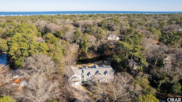 drone / aerial view with a water view and a view of trees