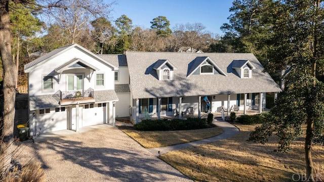 view of front of property featuring a garage, driveway, and a porch