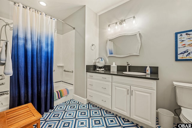 bathroom featuring toilet, baseboards, shower / bath combination with curtain, and vanity