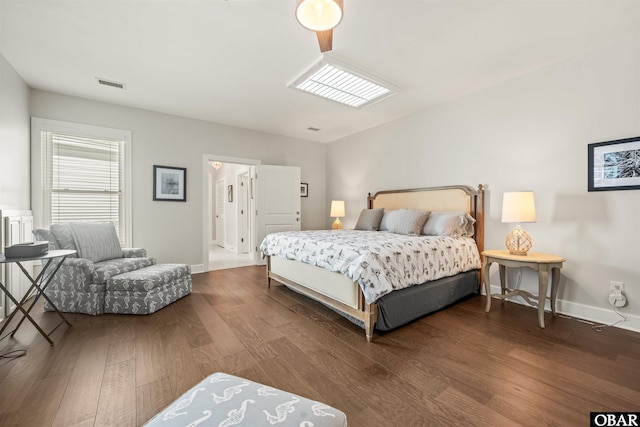 bedroom with baseboards, visible vents, and dark wood-style flooring