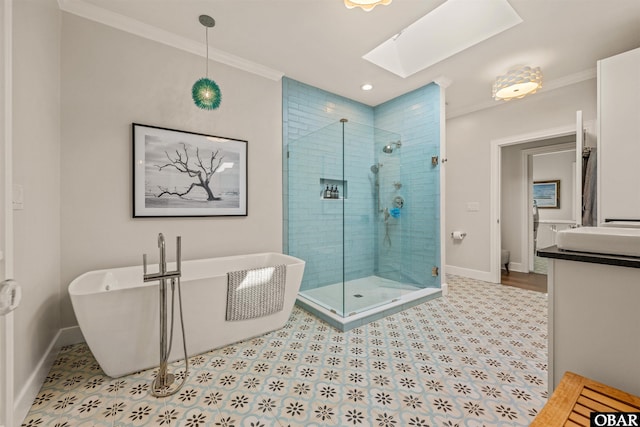 full bath with a soaking tub, baseboards, crown molding, and a stall shower