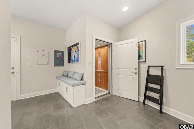 foyer entrance with recessed lighting, electric panel, and baseboards