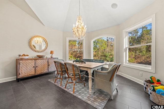 dining space with baseboards, vaulted ceiling, and a chandelier