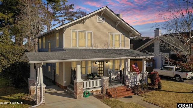 view of front facade featuring a porch and a shingled roof