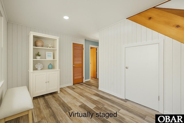 interior space with baseboards, recessed lighting, and light wood-style floors