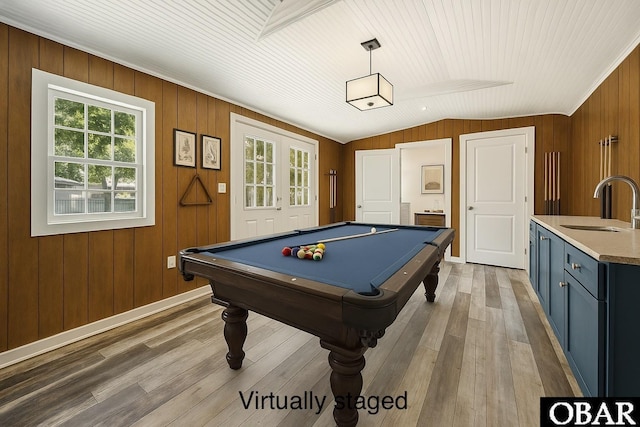 recreation room with hardwood / wood-style floors, vaulted ceiling, wood walls, billiards, and a sink