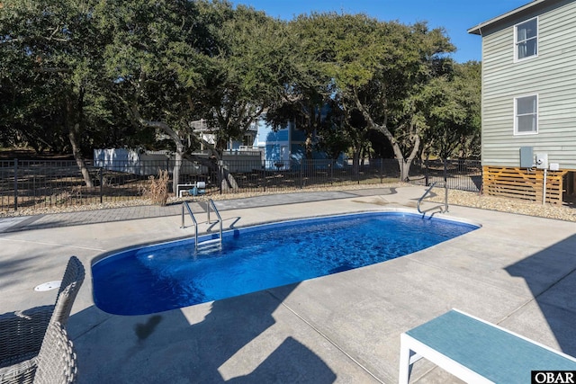 view of swimming pool with a patio, fence, and a fenced in pool