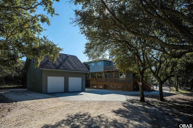 view of front of home with driveway, stairs, a porch, and a garage