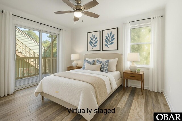 bedroom featuring access to exterior, wood finished floors, and baseboards