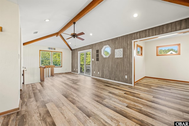 unfurnished living room with hardwood / wood-style flooring, visible vents, a ceiling fan, and baseboards