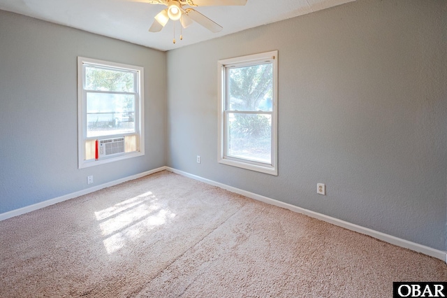 carpeted spare room with cooling unit, a ceiling fan, and baseboards