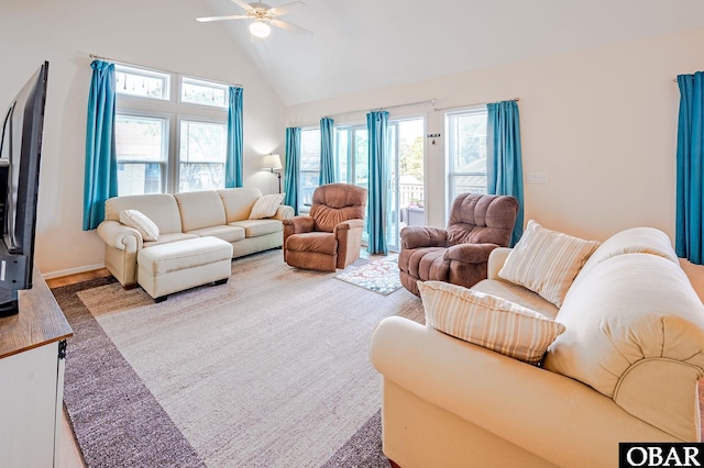 living area featuring high vaulted ceiling and ceiling fan