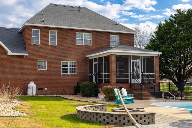 rear view of house featuring fence, roof with shingles, a patio area, and a sunroom