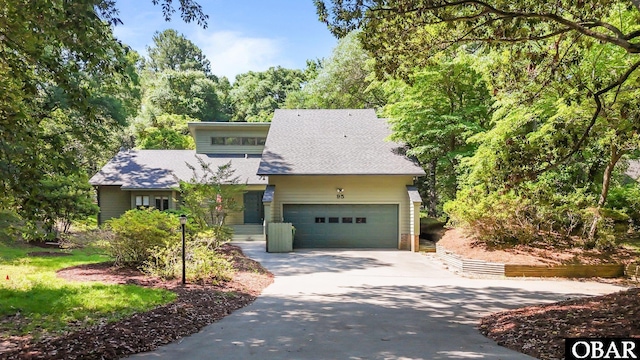 95 Old Passage Ln Lot 440, Southern Shores, NC 27949 - mid-century modern home featuring driveway, a shingled roof, and a garage