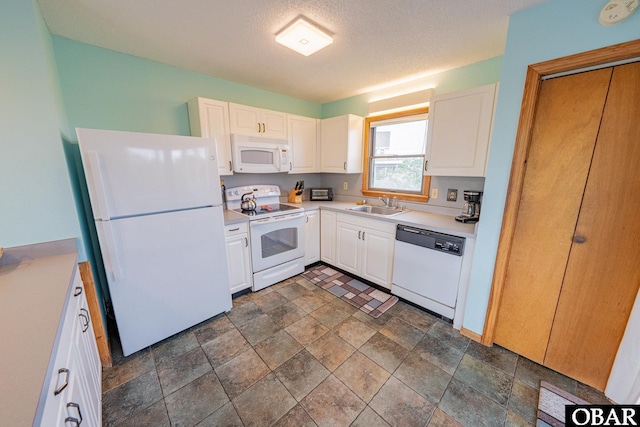 26224 Cutlass Ln Lot 27, Salvo, NC 27972 - kitchen featuring white appliances, stone finish flooring, white cabinetry, light countertops, and a textured ceiling