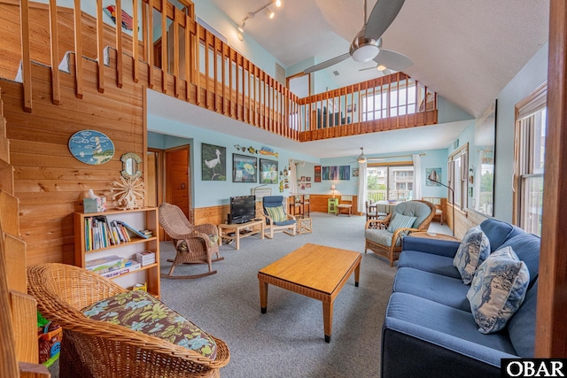 26224 Cutlass Ln Lot 27, Salvo, NC 27972 - carpeted living area with ceiling fan, wooden walls, a high ceiling, wainscoting, and track lighting