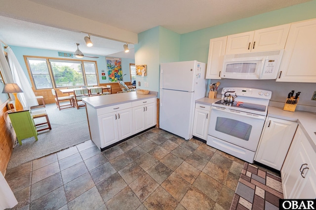 26224 Cutlass Ln Lot 27, Salvo, NC 27972 - kitchen featuring white appliances, a peninsula, light countertops, and white cabinets