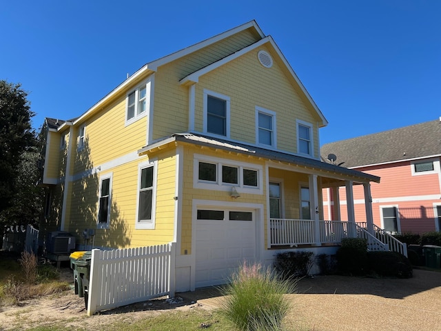 view of front of property with central AC unit, metal roof, a standing seam roof, fence, and a porch